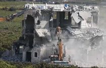 Israeli army bulldozers demolishing a building in Hebron