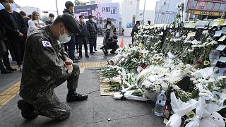 A South Korean army soldier pays tribute to victims of a deadly accident following Saturday night's Halloween festivities on a street near the scene in Seoul, 1 November 2022