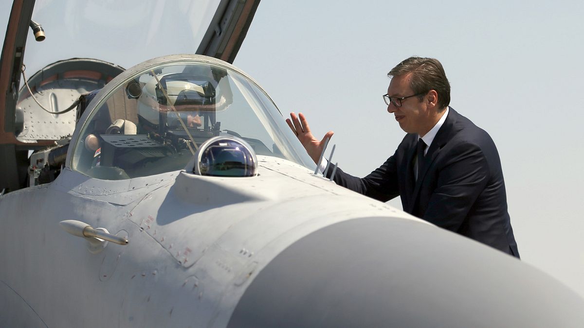 Serbian President Aleksandar Vucic speaks with a pilot of MiG-29 jet fighter on the tarmac at Batajnica near Belgrade, August 2018