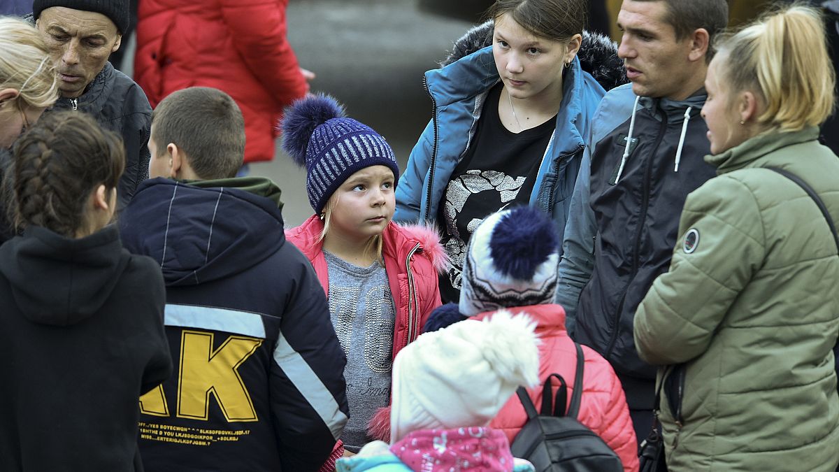 Evacuees from Kherson gather upon their arrival at the railway station in Dzhankoi, Crimea, on Wednesday, Nov. 2, 2022. Kyiv has accused Moscow of "expulsions".