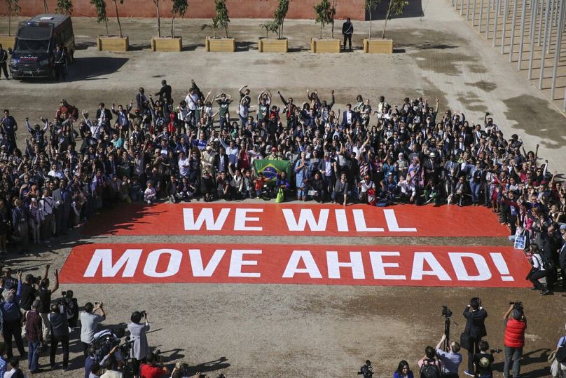 Participants at the COP22 climate conference pose in support of climate negotiations and Paris agreement, on the last day of the conference, in Marrakech, November 2016