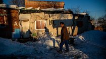A man walks in front of his house covered with snow at the Canada Real shanty town, outside Madrid, Spain, Tuesday, Jan. 12, 2021.