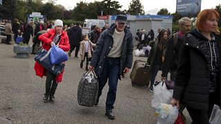 Evacuees from Kherson gather upon their arrival at the railway station in Anapa, southern Russia, Tuesday, Oct. 25, 2022.