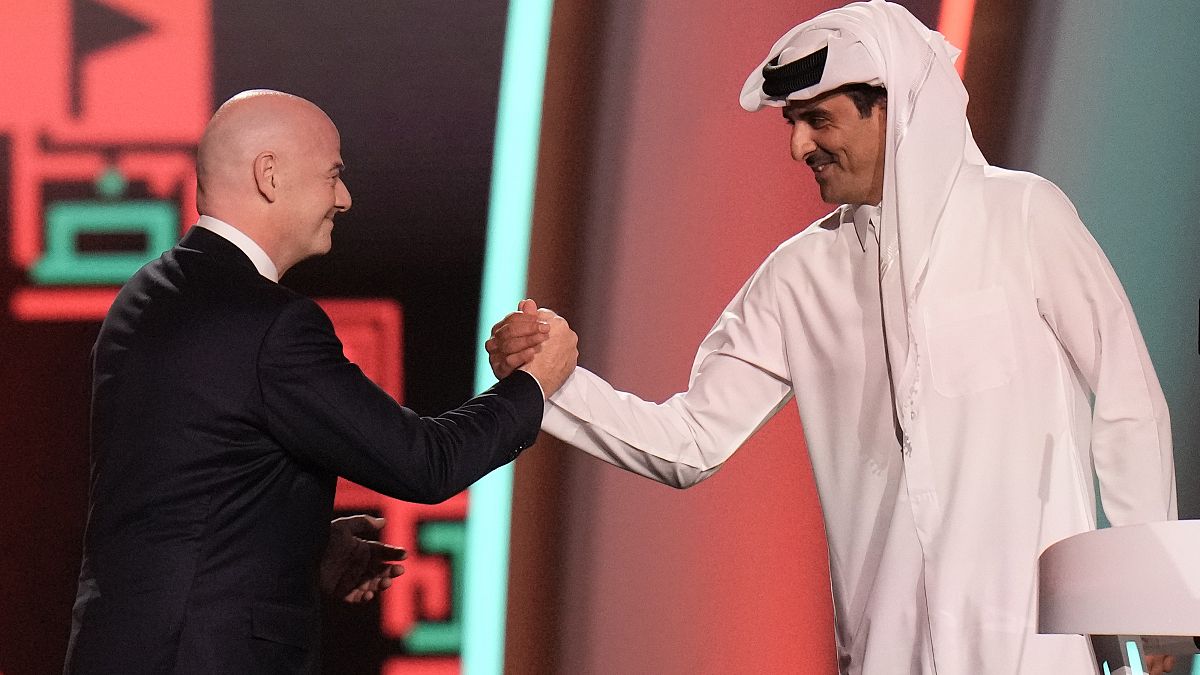 FIFA President Gianni Infantino, left, and Emir of Qatar Sheikh Tamim bin Hamad Al Thani shake hands before the World Cup draw, Doha, Qatar, Friday, April 1, 2022.