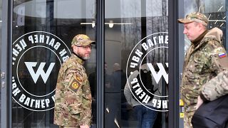 Visitors wearing military camouflage at the entrance of the 'PMC Wagner Centre', the private military group's HQ, during the official opening, St Petersburg, Nov 4, 2022.