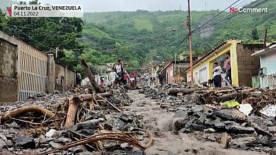Locals removing the debris left by the landslide. 