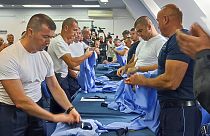 Serb police officers took off their uniforms in the town of Zvecan, Kosovo, Saturday, Nov. 5, 2022.