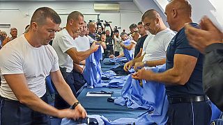 Serb police officers took off their uniforms in the town of Zvecan, Kosovo, Saturday, Nov. 5, 2022.