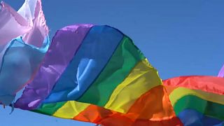 Pride and transgender flags waving on 9 de Julio Avenue