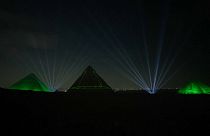 The illuminated pyramids light up the night sky 