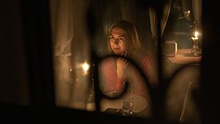 A woman sits in a cafe during a blackout in the Ukrainian capital.