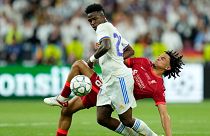 Liverpool's Trent Alexander-Arnold fights for the ball with Real Madrid's Vinicius Junior, left, during the Champions League final soccer match between Liverpool and Real Madr