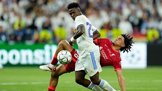 Liverpool's Trent Alexander-Arnold fights for the ball with Real Madrid's Vinicius Junior, left, during the Champions League final soccer match between Liverpool and Real Madr