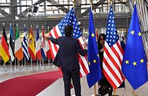 A member of protocol puts up the European Union and U.S. flags prior to the arrival of U.S. President Joe Biden for an EU summit in Brussels, Thursday, March 24, 2022.