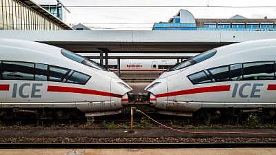 Two engines of an Inter-City Express (ICE) train of German railway operator Deutsche Bahn (DB) are seen at a platform of Munich's main railway station on November 2, 2022.