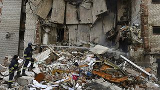 Firefighters work at the scene of a damaged residential building after Russian shelling in the liberated Lyman, Donetsk region, 7 November 2022