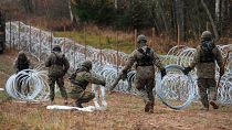 Polish soldiers begin laying a razor wire barrier along Poland’s border with the Russian exclave of Kaliningrad in Wisztyniec, Poland.