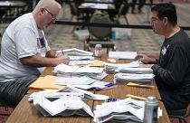 Workers count absentee ballots at the Wisconsin Center for the 2022 midterm elections in Milwaukee