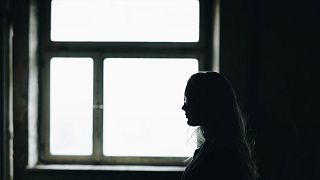 Illustrative photo of a girl in a dark room