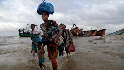 Displaced families arrive after being rescued by boat from a flooded area of Buzi district, Mozambique after cyclone Idai in 2019. Displaced families arrive after being rescued by boat from a flooded area of Buzi district, Mozambique after cyclone Idai in 2019.