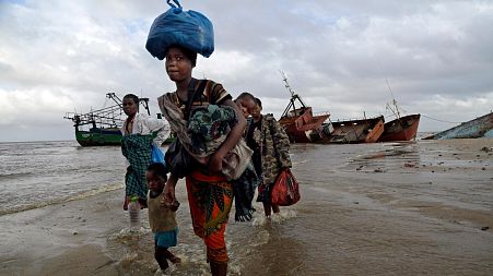 Displaced families arrive after being rescued by boat from a flooded area of Buzi district, Mozambique after cyclone Idai in 2019.