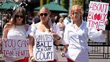 Campaigners from Address The Dress Code outside the main gate at Wimbledon - July 2022