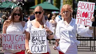 Campaigners from Address The Dress Code outside the main gate at Wimbledon - July 2022