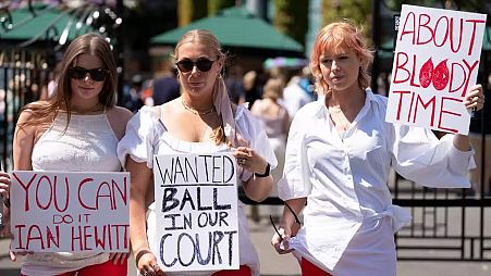 Campaigners from Address The Dress Code outside the main gate at Wimbledon - July 2022