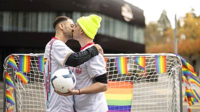 Two men kiss outside the Fifa museum in Switzerland