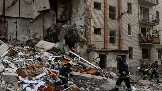 Firefighters work at the scene of a damaged residential building after Russian shelling in the liberated Lyman, Donetsk region, Ukraine, Monday, Nov. 7, 2022.