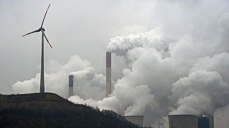 A wind turbine overlooks the coal-fired power station in Gelsenkirchen, Germany, on Dec. 1, 2014.