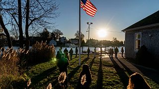 Voters line up to cast their ballots in the midterm election at the Aspray Boat House in Warwick, Rhode Island, Tuesday, Nov. 8, 2022.