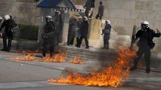 Molotov cocktails were thrown at riot police outside the Greek Parliament during clashes in Athens.