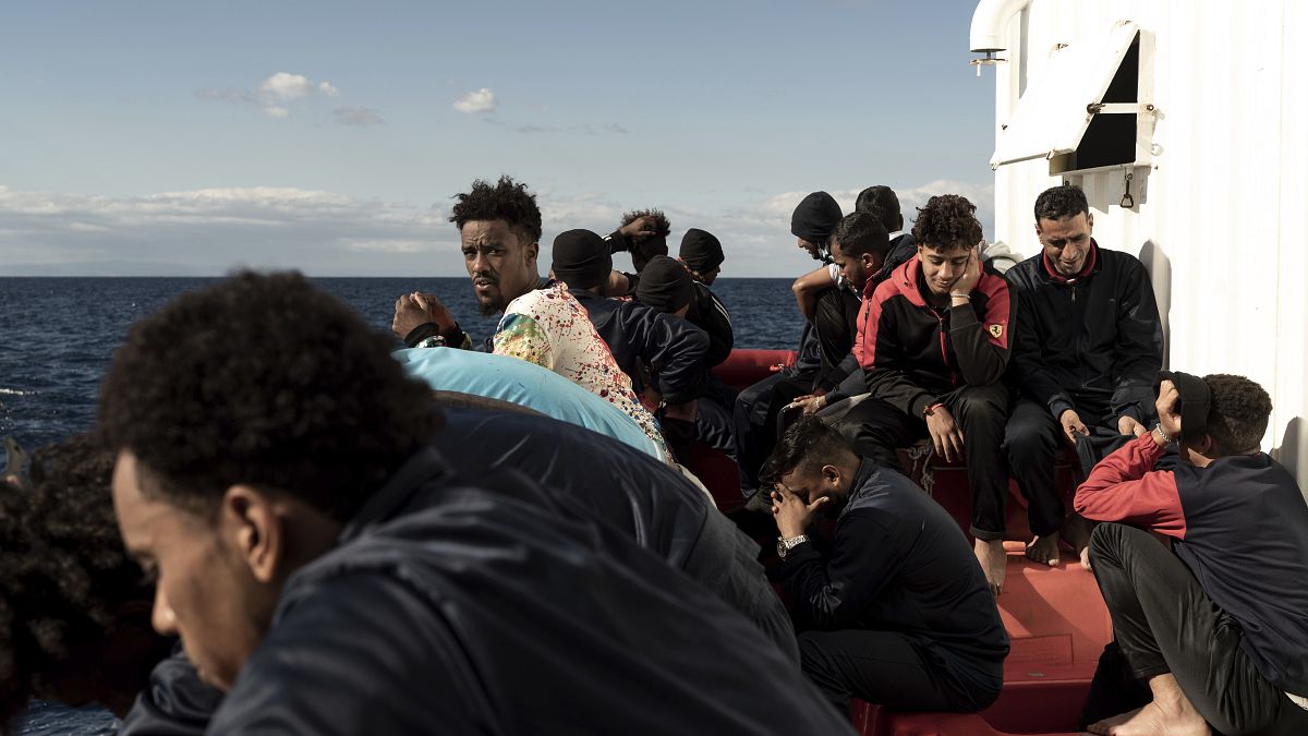 Migrants gather on the deck of the Ocean Viking rescue ship.