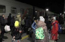 Kherson evacuees board trains at Crimea station in late October