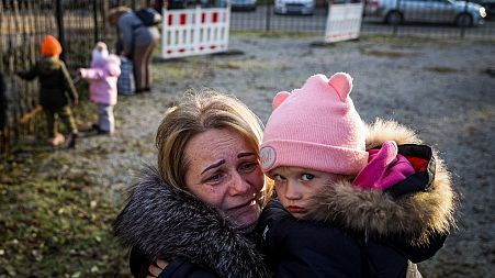 Svetlana Titova, 52, hugs her granddaughter as they arrive from the Russian-held town of Berdyansk, November 7, 2022.