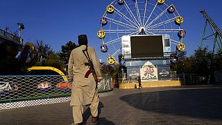 A Taliban fighter stands guard in an amusement park, in Kabul, Afghanistan, Thursday, Nov. 10, 2022.