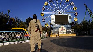 A Taliban fighter stands guard in an amusement park, in Kabul, Afghanistan, Thursday, Nov. 10, 2022. 