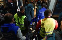 Volunteers and paramedics carry an elderly evacuee from Kherson into a hall on Nov. 10th 2022
