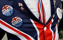 Pro-Brexit supporter wears badges as he demonstrates outside Parliament in London, Oct. 28, 2019. 