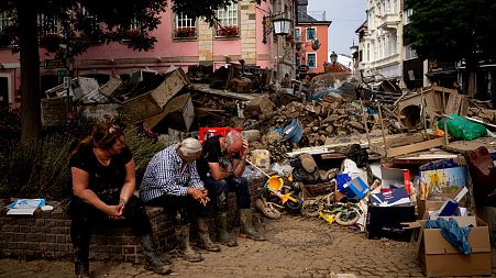 people rest from cleaning up the debris of the flood disaster in Bad Neuenahr-Ahrweiler, Germany..