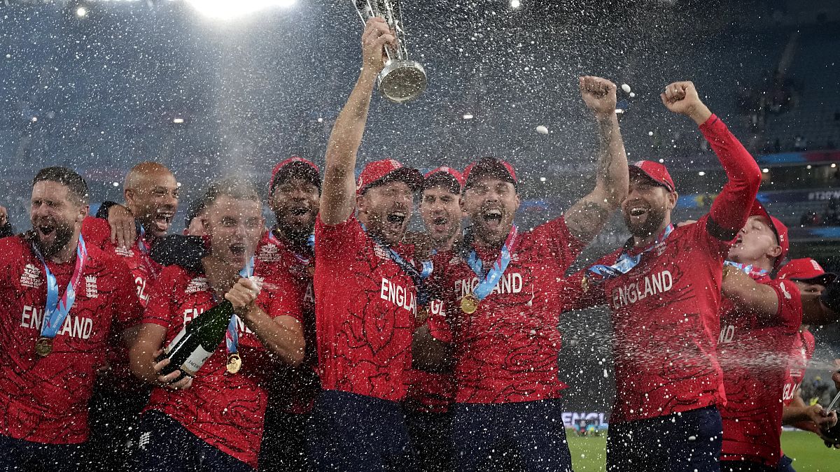 England's captain Jos Buttler holds the winners trophy and celebrates with his teammates after their win against Pakistan in the final of the T20 World Cup