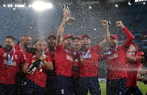 England's captain Jos Buttler holds the winners trophy and celebrates with his teammates after their win against Pakistan in the final of the T20 World Cup