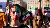 People stage a protest against the death of Mahsa Amini, a woman who died while in police custody in Iran, during a rally in central Rome, Oct. 29, 2022. 