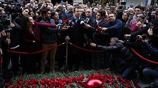 Ekrem  Imamoglu, mayor of Istanbul, speaking to press with mourners as after blast attack