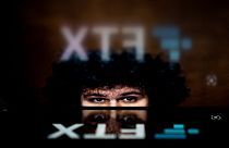 This photo illustration shows the logo of cryptocurrency FTX, reflected in an image of former chief executive Samuel Bankman-Fried, in Washington, DC, on November 13, 2022.