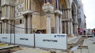 Newly-installed glass barriers have managed to keep a high tide from flooding Venice’s ancient basilica.