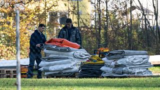 Two men dismantle tents tents that were set up as shelters for refugees in St. Georgen im Attergau, Austria, Monday, Nov. 14, 2022. 