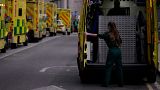 A paramedic opens the doors of an ambulance to take a patient into the Royal London Hospital in the Whitechapel area of east London,. 