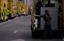 A paramedic opens the doors of an ambulance to take a patient into the Royal London Hospital in the Whitechapel area of east London,.